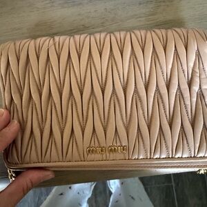 Miu Miu Beige Quilted Women's wallet on chai.